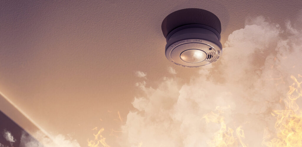 home safety - smoke detector on ceiling detecting house fire